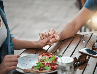 Praying, holding hands and faith of couple, food and together in weekend, pizza and gratitude for lunch. Outdoor, religion and people at home, Christian and brunch for vegan, respect and spiritual