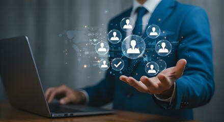 Fototapeta premium HR Technology: Businessman Using Laptop with Virtual Team Icons, Human Resources Management, Talent Acquisition, Recruitment, and Networking