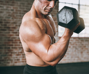 Fitness, man and dumbbell for bicep curl in gym for workout, exercise and resistance training. Arm,...