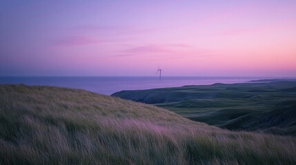 Obraz premium Serene coastal sunset landscape with a single wind turbine on the horizon, overlooking grassy dunes.