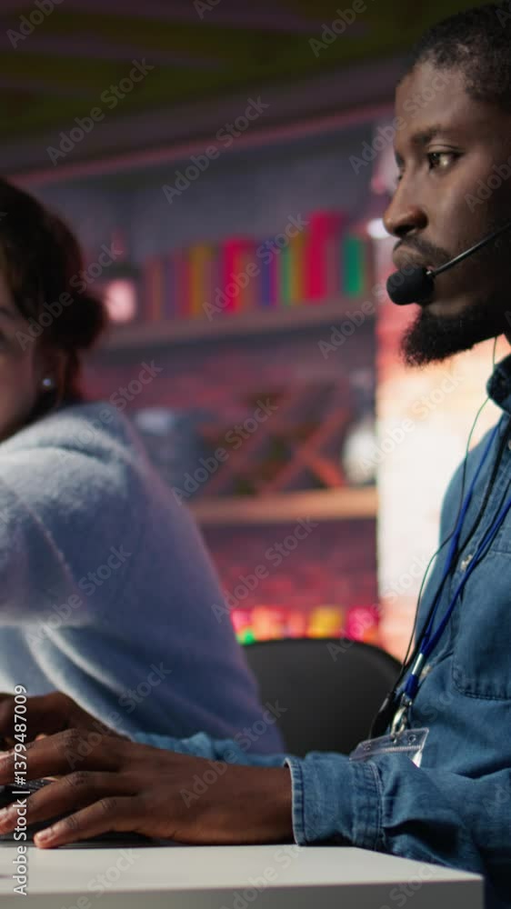 Poster vertical video manager supervising technical support specialist in call center office doing troubles