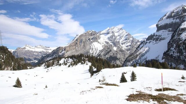 Low snow levels in Swiss alps, wide mountain landscape