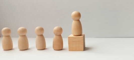 Leadership in action wooden figures representing team dynamics minimalist setting conceptual perspective