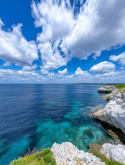 Coastal cliffs, turquoise water, and a vibrant blue sky filled with fluffy clouds