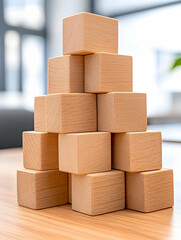 Obraz premium Pyramid of light brown wooden blocks on a table