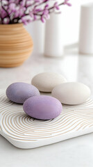 Three pastel-colored stones on a decorative tray