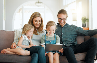 Love, smile and tablet with family on sofa in living room of home for bonding together. Happy, relax or streaming with mother, father and girl children in apartment for development or growth
