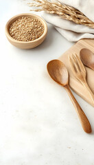 Wooden utensils, brown rice, and wheat on a white background