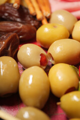 Olives and dried fruits arranged on a colorful platter