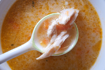 Warm soup with chicken and vegetables in a cozy kitchen setting