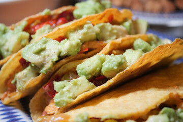 Tasty tacos filled with fresh ingredients and guacamole served warm