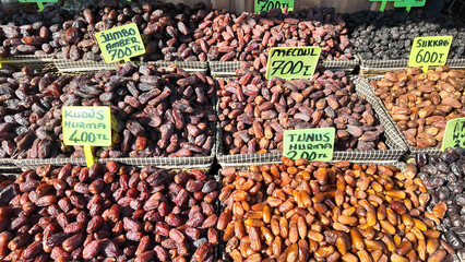 Variety of fresh dates displayed at a market in the afternoon sun