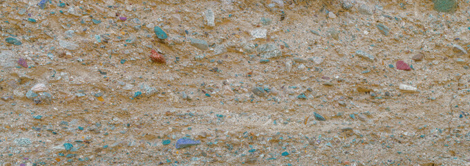 Macro image of sedimentary mudstone made up of colorful stones.