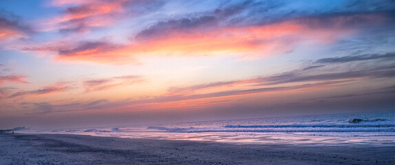 Vibrant Pastel Sunset Over a Peaceful Ocean Shoreline