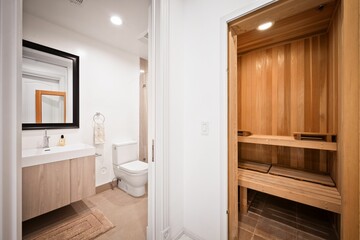 Stylish bathroom with a wooden sauna, white walls, and a contemporary vanity with a large mirror.
