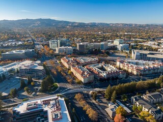 Aerial view of Pleasanton, California, USA, showcasing the city's urban landscape, architecture, and transportation infrastructure during the autumn season.