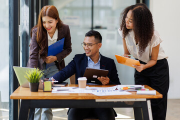 Group of confident business people point to graphs and charts to analyze market data, balance sheet, account, net profit to plan new sales strategies to increase production capacity.	
