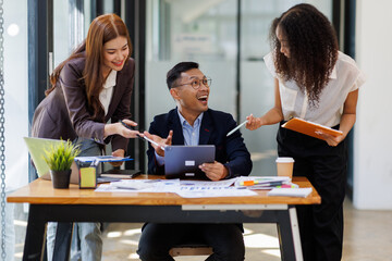 Group of confident business people point to graphs and charts to analyze market data, balance sheet, account, net profit to plan new sales strategies to increase production capacity.	
