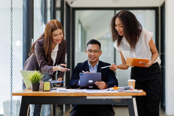 Group of confident business people point to graphs and charts to analyze market data, balance sheet, account, net profit to plan new sales strategies to increase production capacity.	
