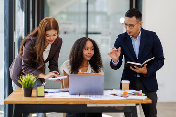 Group of confident business people point to graphs and charts to analyze market data, balance sheet, account, net profit to plan new sales strategies to increase production capacity.	
