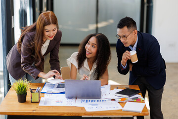 Group of confident business people point to graphs and charts to analyze market data, balance sheet, account, net profit to plan new sales strategies to increase production capacity.	
