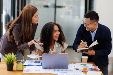 Group of confident business people point to graphs and charts to analyze market data, balance sheet, account, net profit to plan new sales strategies to increase production capacity.	
