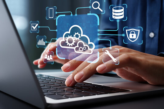 Cloud orchestration and interoperability. Cloud automation management and integration. Businessman using laptop computer to manage cloud computing systems.