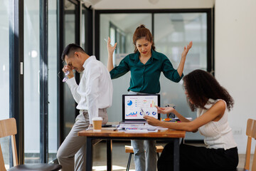  teamwork of tired young business with documents tax laptop computer in office. Sad, unhappy, Worried, Depression, or employee life stress concept
