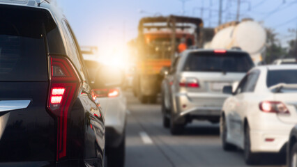 Luxury of black car stop on the concrete road with many cars. Traveling in the provinces during the bright period. Traffic during peak hours on day time.