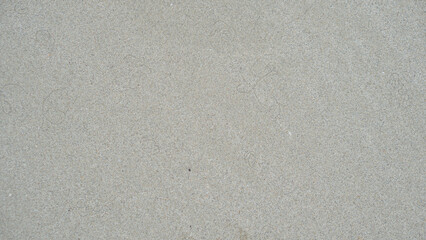 Fine sandy beach at the coast. Wet areas with curved lines. for background and textured.