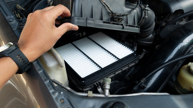 Owner hand is repairing the car and opening the air filter conditioner cover. with change to new air filter. for maintenance and service car.