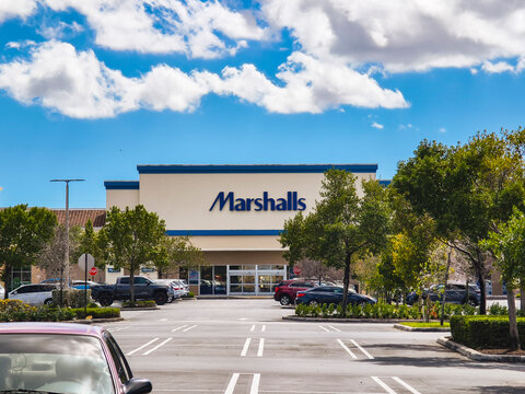 Miami Gardens, Florida: Feb 26, 2024 - Wide view of Marshalls store at Gardens Promenade Mall with parked cars and trees in foreground.