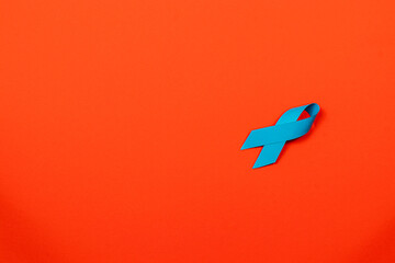 Blue ribbon on an orange background promoting cancer awareness and support
