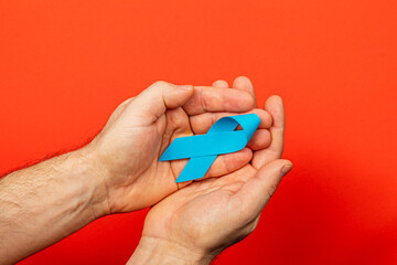 Support for cancer awareness with a blue ribbon for detection and prevention