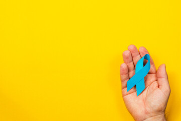 Support cancer awareness with a blue ribbon representing hope and courage