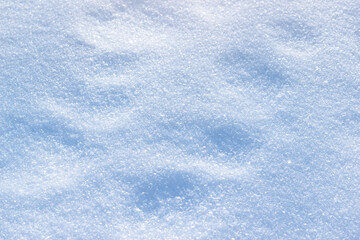 The natural snow surface with morning sunlight. Winter background.