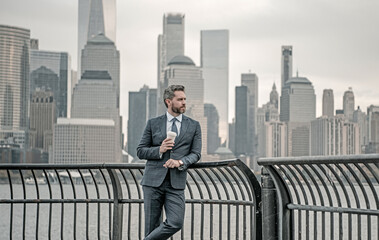 Freelancer. Handsome mature businessman walk outside. Businessman walking on the street in New...
