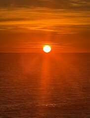Red sun setting over the sea