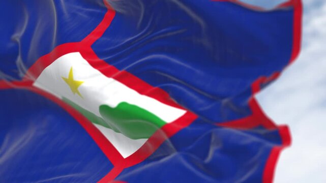 close-up of Sint Eustatius flag waving in the wind on a clear day. Dutch island in the Caribbean. Seamless 3d render animation. Slow motion loop. Selective focus.