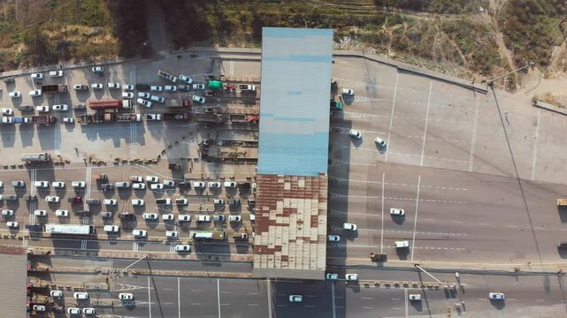Top-down view of the toll booth collecting road maintenance fee form the vehicles.