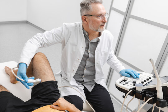 Ultrasound imaging for inguinal hernia. Man with leg pain came to medical clinic for an ultrasound examination of groin