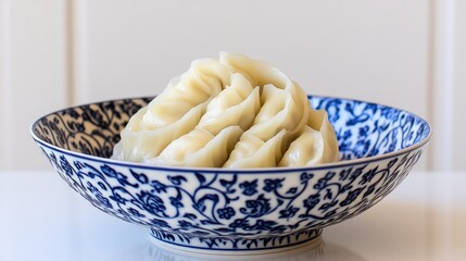 A creative presentation of dumplings stacked in a spiral on a decorative plate