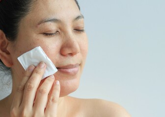 Woman holding cotton pad in hand, health concept