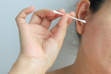 Woman holding cotton swab in hand, health concept