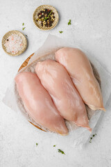 Fototapeta premium various parts of raw chicken on a light background
