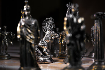 Ancient Mythology Chess Pieces in Dramatic Lighting