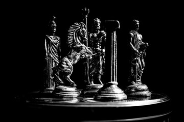 Ancient Mythology Chess Pieces in Dramatic Lighting