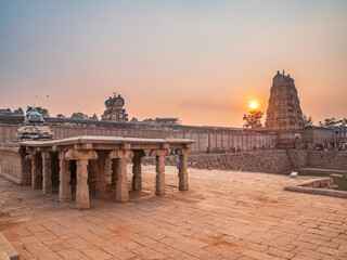 sunset panoramic view amazing temple complex at Hampi, world famous unesco site, ancient stone walls and mysterious gateways in Karnataka, India