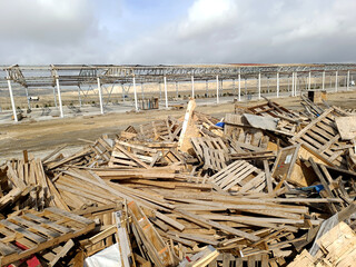 Wood waste collected for recycling outdoors in the Waste Center area. Mixed wood waste. Iron...