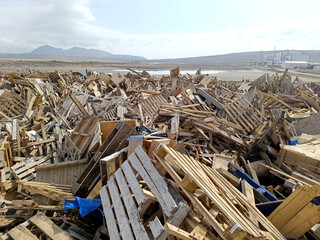 Wood waste collected for recycling outdoors in the Waste Center area. Mixed wood waste. Iron...